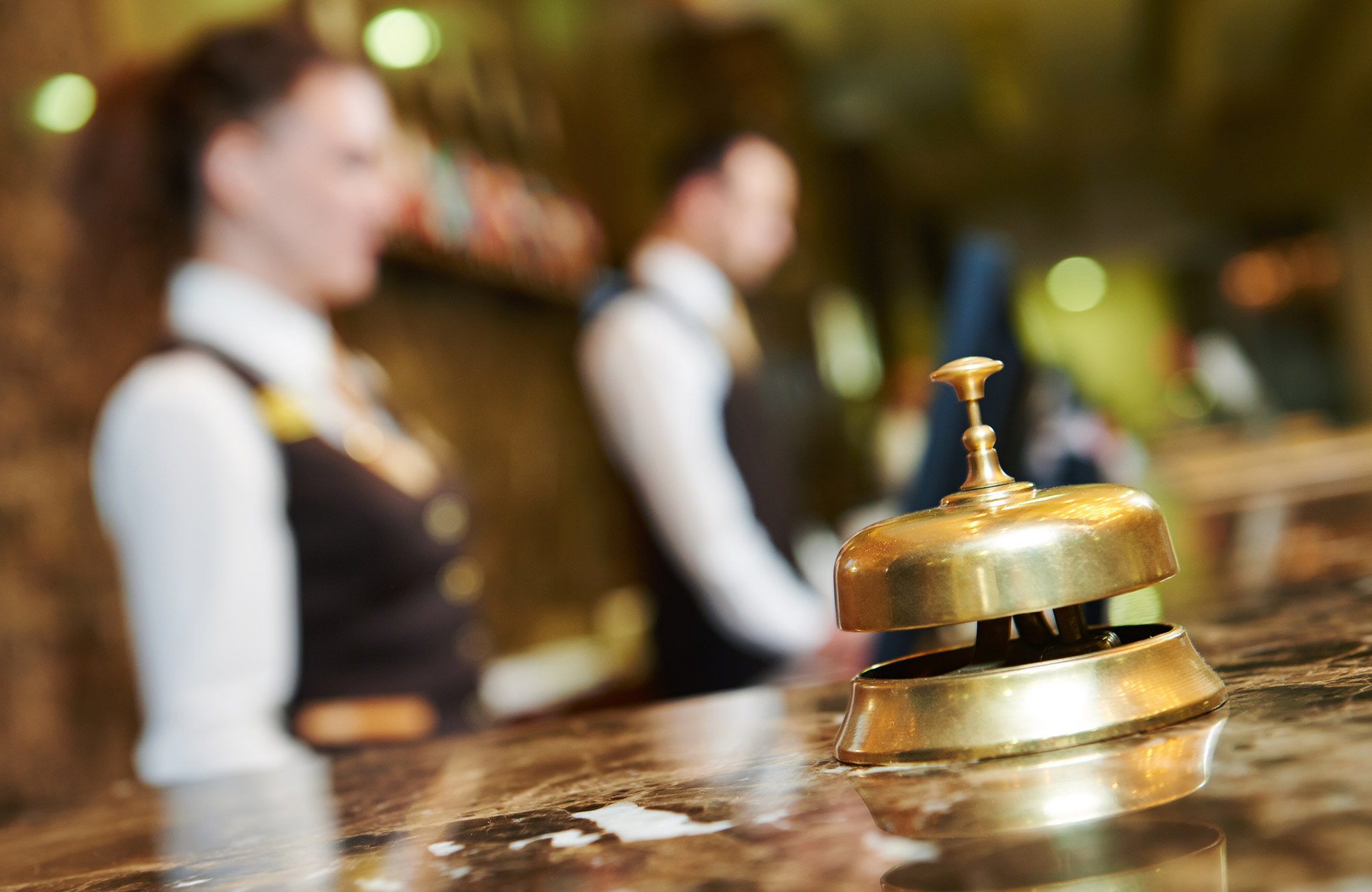 A photo of a bellhop bell on a counter at a hotel
