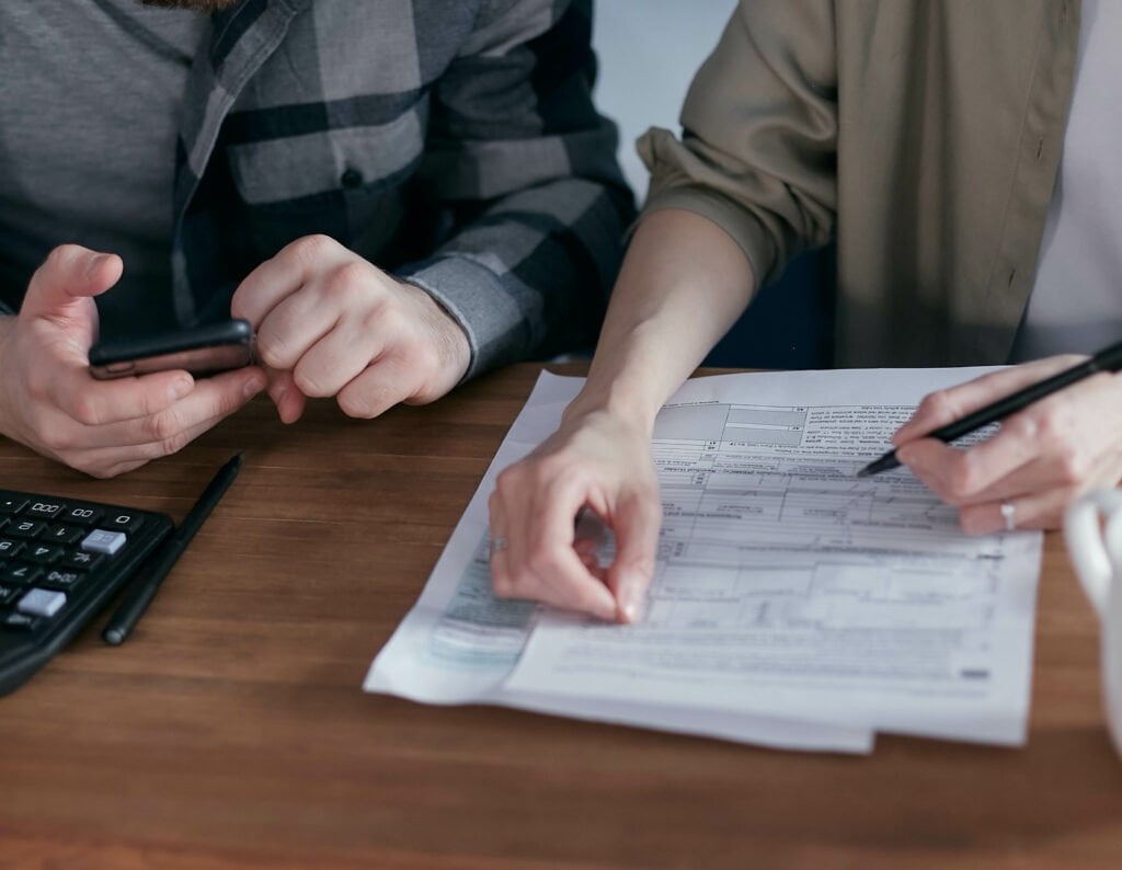 Two men checking their paperwork