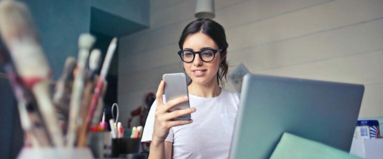 Woman in an art studio on her phone