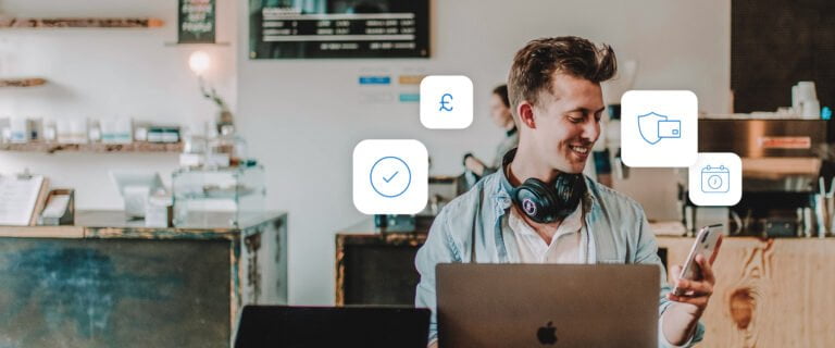 Man on his laptop and looking at his phone, surrounded by payment icons